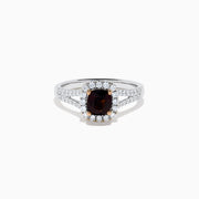 The 18K White Gold GIA Certified Alexandrite and Diamond Ring showcases a cushion-cut Alexandrite surrounded by white diamonds. Its split band is adorned with diamonds, adding elegance, and the ring is displayed against a plain white background.