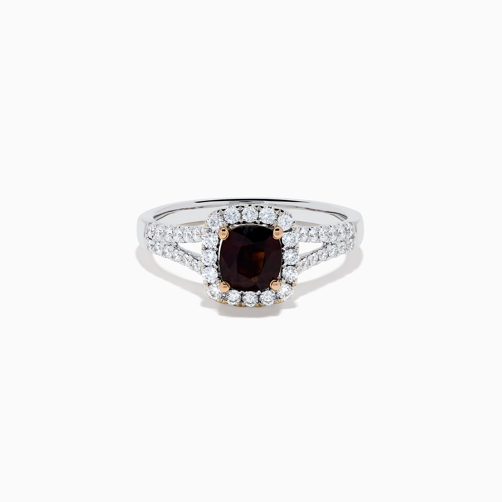 The 18K White Gold GIA Certified Alexandrite and Diamond Ring showcases a cushion-cut Alexandrite surrounded by white diamonds. Its split band is adorned with diamonds, adding elegance, and the ring is displayed against a plain white background.