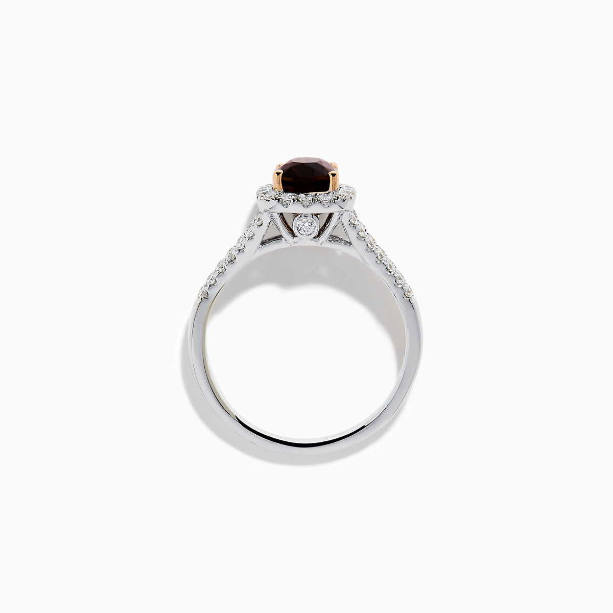 The 18K White Gold GIA Certified Alexandrite and Diamond Ring showcases a cushion-cut Alexandrite surrounded by white diamonds. Its split band is adorned with diamonds, adding elegance, and the ring is displayed against a plain white background.