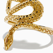 The 14K Yellow Gold Snake Ring features a coiled serpent design with detailed scales, elegantly wrapping around the finger. Displayed against a plain white background, this striking ring is crafted in yellow gold.