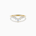 The D’Oro 14K Yellow Gold Diamond Curved Wedding Band features a chevron design with seven round white diamonds of varying sizes set along the pointed curve, shown against a white background.