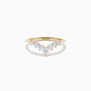 The D’Oro 14K Yellow Gold Diamond Curved Wedding Band features a chevron design with seven round white diamonds of varying sizes set along the pointed curve, shown against a white background.