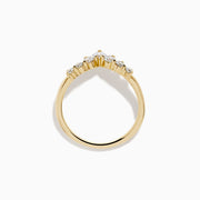 The D’Oro 14K Yellow Gold Diamond Curved Wedding Band features a chevron design with seven round white diamonds of varying sizes set along the pointed curve, shown against a white background.