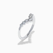 The Classique 14K White Gold Diamond Wedding Band showcases a delicate V-shaped design with sparkling round diamonds elegantly set along the band’s curve.
