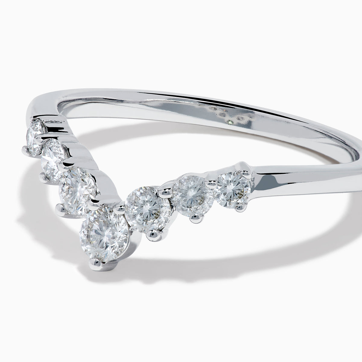 The Classique 14K White Gold Diamond Wedding Band showcases a delicate V-shaped design with sparkling round diamonds elegantly set along the band’s curve.
