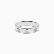 The 925 Sterling Silver Diamond Ring features three evenly spaced round diamonds set into a sleek silver band, shown against a plain white background.