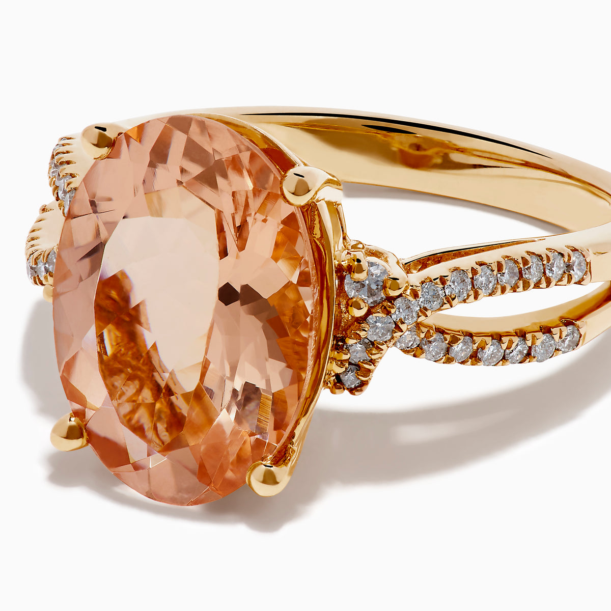The 14K Rose Gold Morganite and Diamond Twist Band Ring features an oval peach morganite center stone with rows of white diamonds on a unique twist band, shown against a white background.