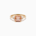 A beautiful 14K Rose Gold Cushion Solitaire Morganite and Diamond Ring featuring a large peach cushion-cut morganite center stone, accented by three round white diamonds on each side.