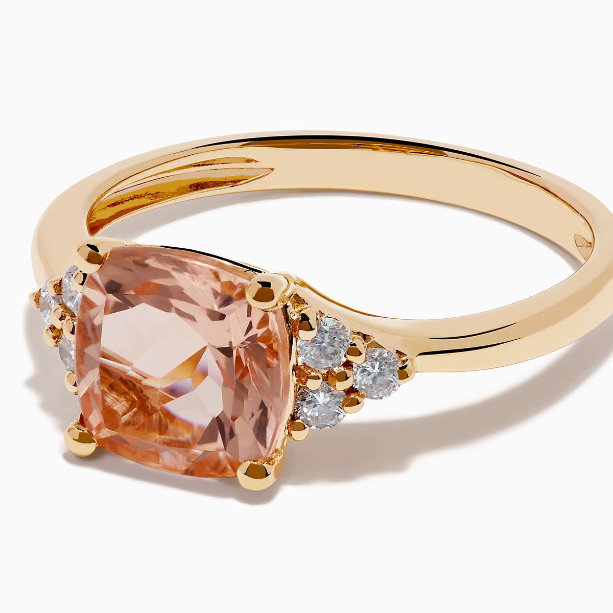 A beautiful 14K Rose Gold Cushion Solitaire Morganite and Diamond Ring featuring a large peach cushion-cut morganite center stone, accented by three round white diamonds on each side.