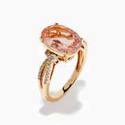The 14K Rose Gold Oval Solitaire Morganite and Diamond Ring features a large pink morganite centerpiece, accented by two rows of sparkling diamonds along the split shank rose gold band.