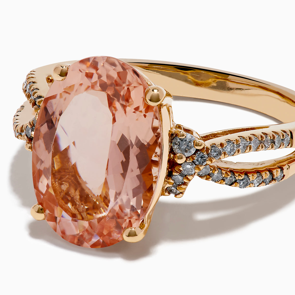 The 14K Rose Gold Oval Solitaire Morganite and Diamond Ring features a large pink morganite centerpiece, accented by two rows of sparkling diamonds along the split shank rose gold band.