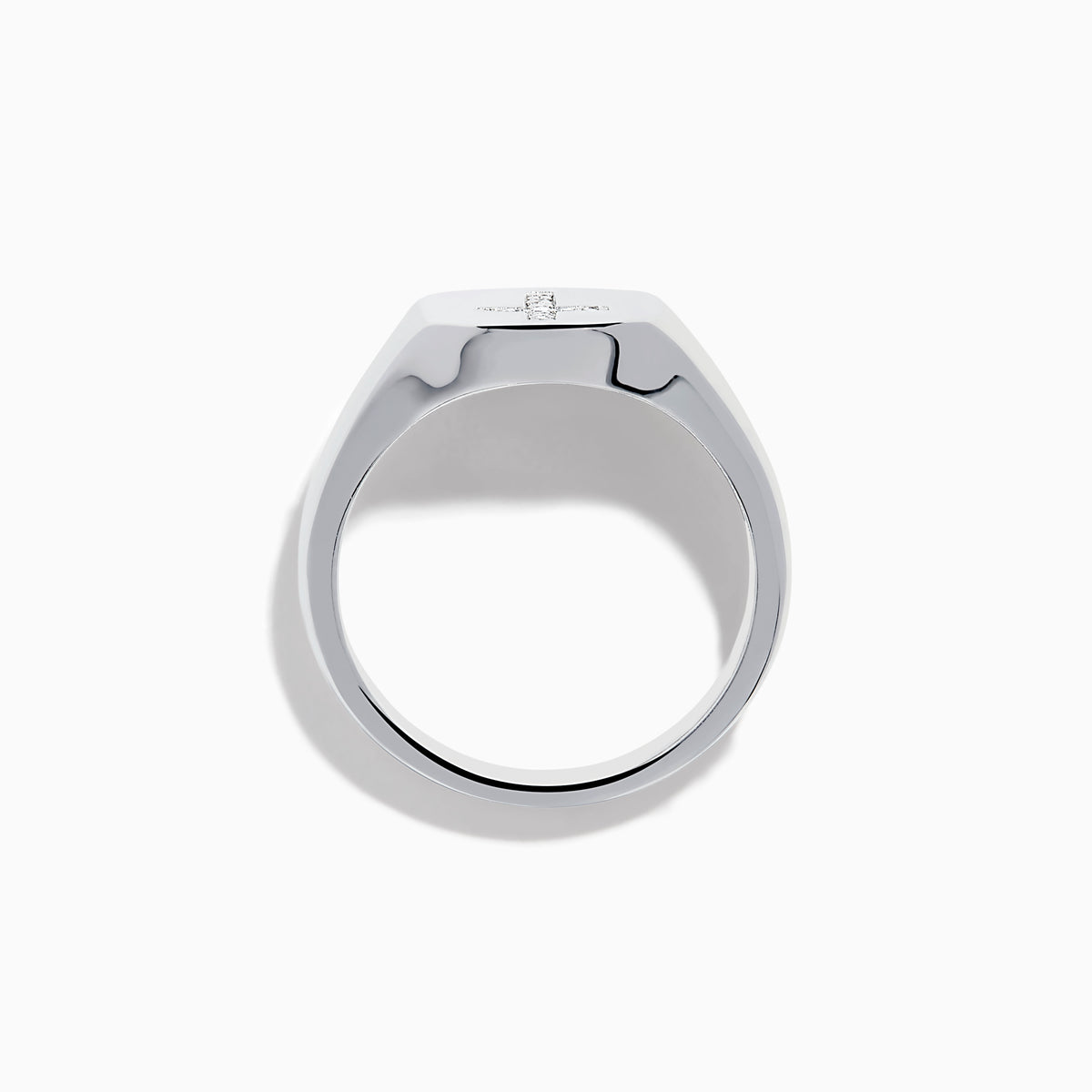 The 925 Sterling Silver Diamond Cross Ring features a flat, oval top with a raised diamond cross set with small white stones against a black background, creating a simple and elegant design.