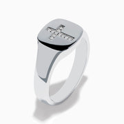 The 925 Sterling Silver Diamond Cross Ring features a flat, oval top with a raised diamond cross set with small white stones against a black background, creating a simple and elegant design.