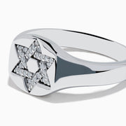 The 925 Sterling Silver Diamond Star of David Ring features a raised, diamond-encrusted Star of David on a polished band, elegantly displayed against a white background.