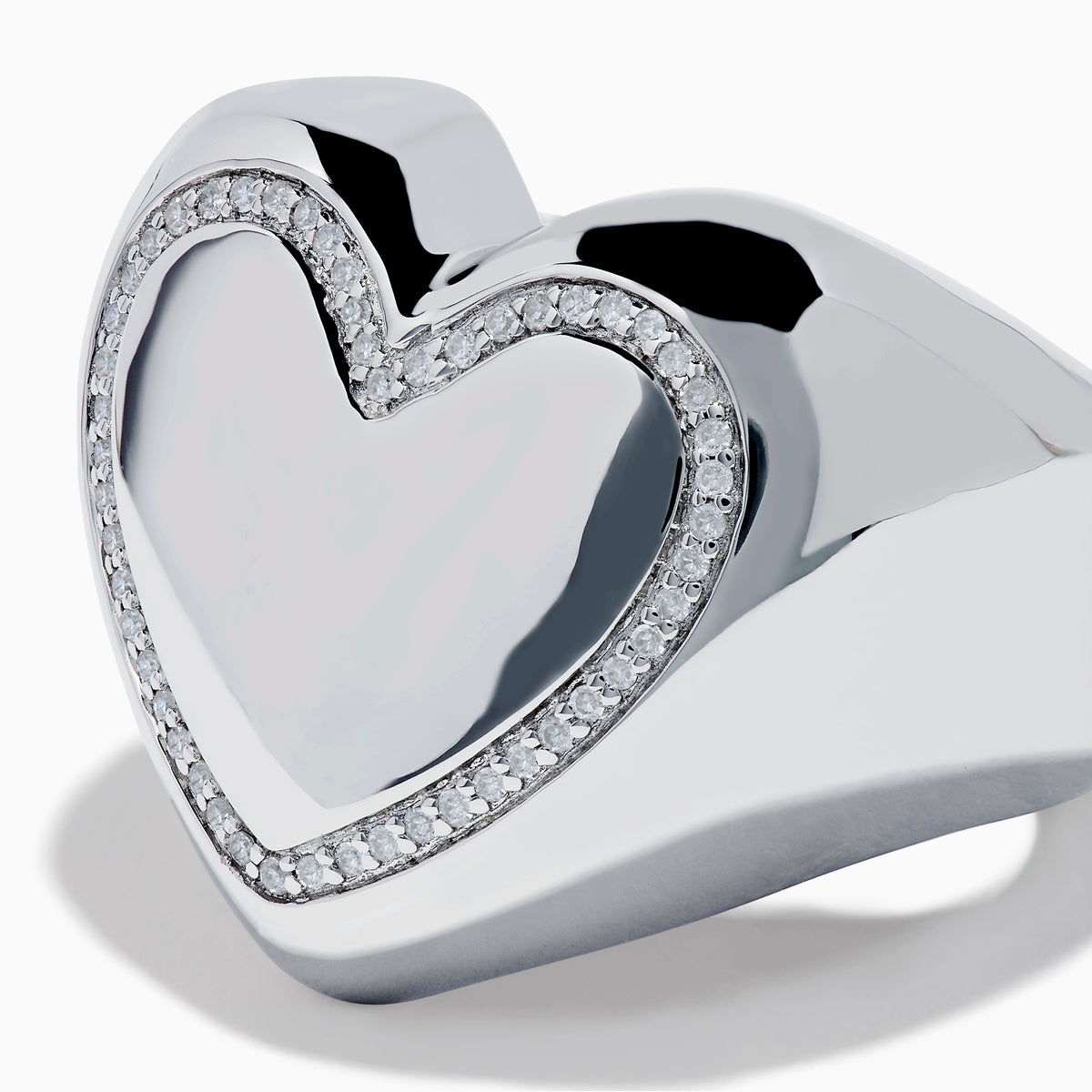 The 925 Sterling Silver Diamond Bubble Heart Ring features a smooth, reflective heart shape bordered by sparkling diamond-like gems, set against a white background.