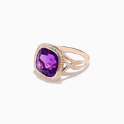 The 14K Rose Gold Amethyst and Diamond Cocktail Ring features a cushion-cut amethyst center, encircled by sparkling round diamonds, all set in elegant rose gold against a white background.