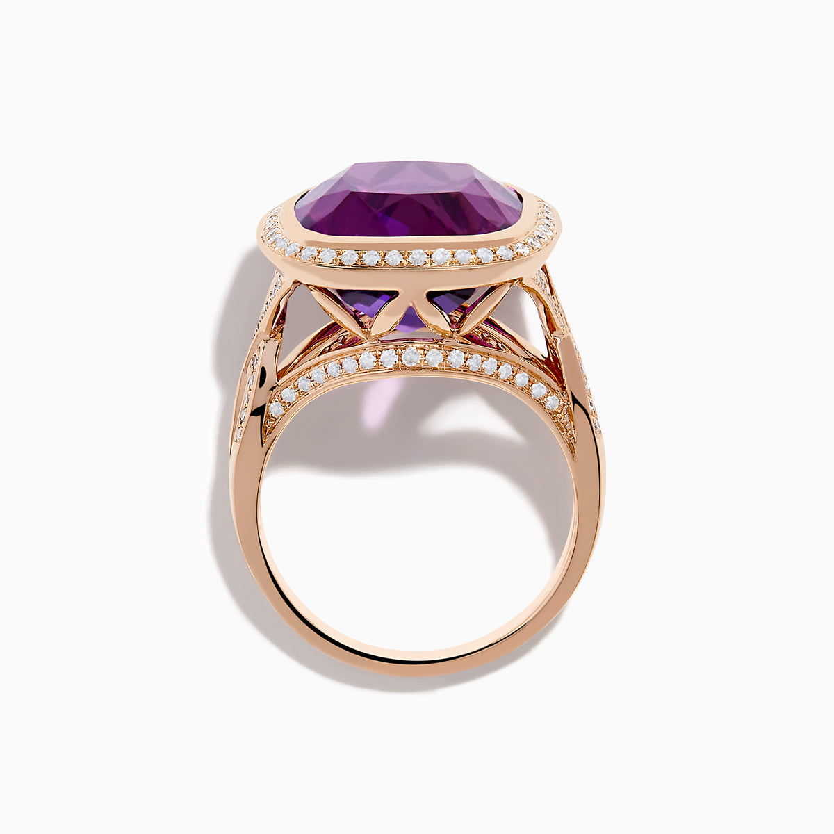 The 14K Rose Gold Amethyst and Diamond Cocktail Ring features a cushion-cut amethyst center, encircled by sparkling round diamonds, all set in elegant rose gold against a white background.