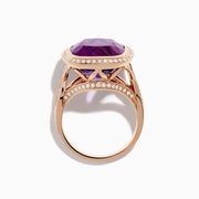 The 14K Rose Gold Amethyst and Diamond Cocktail Ring features a cushion-cut amethyst center, encircled by sparkling round diamonds, all set in elegant rose gold against a white background.