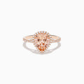 The Blush 14K Rose Gold Morganite and Diamond Ring features a large pear-shaped morganite framed by a halo of sparkling diamonds, with additional diamonds set along the band for added brilliance.