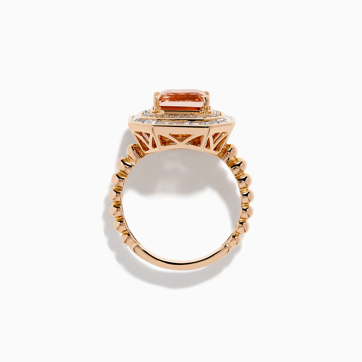 The 14K Rose Gold Morganite and Diamond Geometric Cocktail Ring showcases a large square peach morganite center, framed by two rows of sparkling white diamonds in a geometric halo, set against a white background.