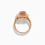 The 14K Rose Gold Morganite and Diamond Geometric Cocktail Ring showcases a large square peach morganite center, framed by two rows of sparkling white diamonds in a geometric halo, set against a white background.