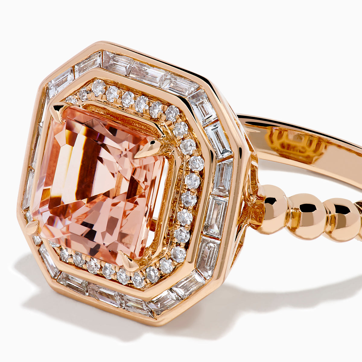 The 14K Rose Gold Morganite and Diamond Geometric Cocktail Ring showcases a large square peach morganite center, framed by two rows of sparkling white diamonds in a geometric halo, set against a white background.