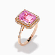 The 14K Rose Gold Kunzite and Diamond Double Halo Ring features a rectangular pink Kunzite, framed by two rows of diamonds on a rose gold band, presented against a plain white background.