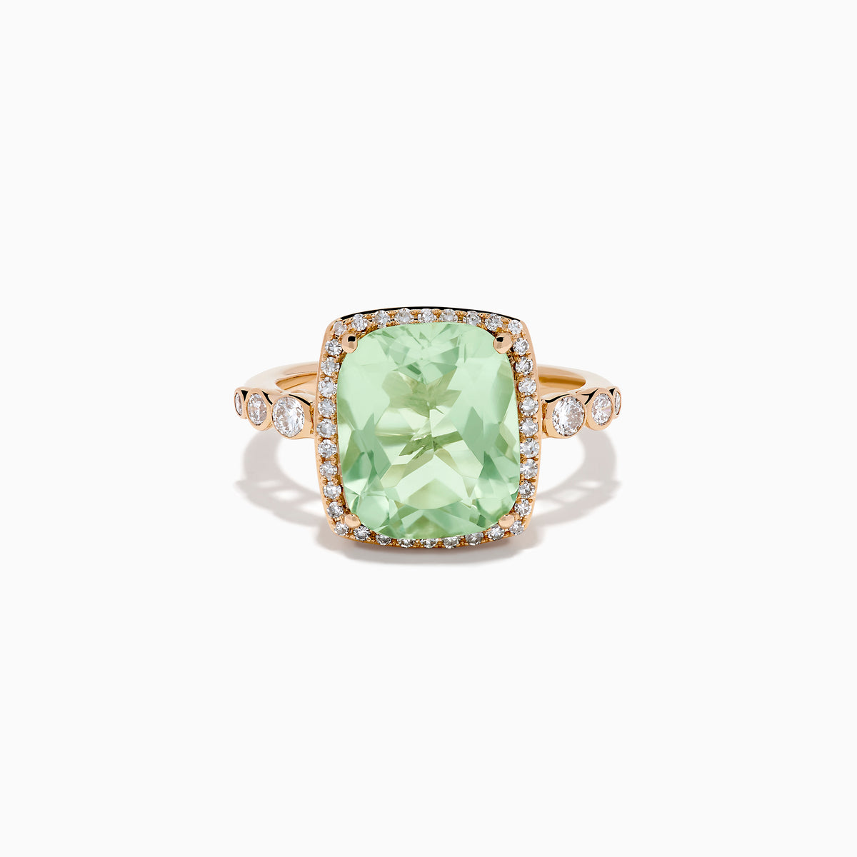 The 14K Rose Gold Green Amethyst and Diamond Halo Cocktail Ring showcases a rectangular light green amethyst center, framed by a sparkling diamond halo with round diamonds accenting the band.