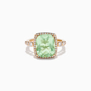 The 14K Rose Gold Green Amethyst and Diamond Halo Cocktail Ring showcases a rectangular light green amethyst center, framed by a sparkling diamond halo with round diamonds accenting the band.
