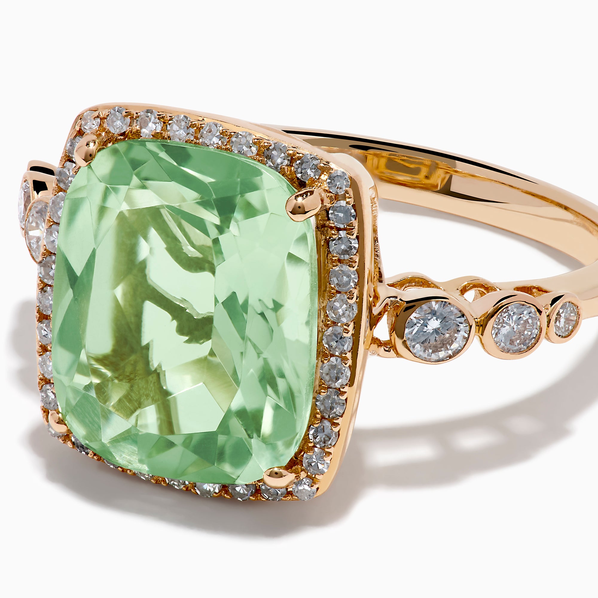 The 14K Rose Gold Green Amethyst and Diamond Halo Cocktail Ring showcases a rectangular light green amethyst center, framed by a sparkling diamond halo with round diamonds accenting the band.