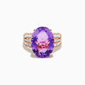 The 14K Rose Gold Purple Amethyst and Diamond Cocktail Ring features a large oval purple amethyst center, accented by three rows of small rectangular diamonds on each side, set in rose gold.
