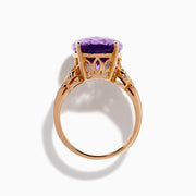 The 14K Rose Gold Purple Amethyst and Diamond Cocktail Ring features a large oval purple amethyst center, accented by three rows of small rectangular diamonds on each side, set in rose gold.