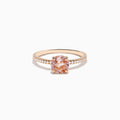 The Blush 14K Rose Gold Morganite and Diamond Ring features a large oval peach morganite center and sparkling diamonds along the band, shown on a white background.