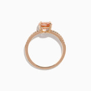 The Blush 14K Rose Gold Morganite and Diamond Ring features a large oval peach morganite center and sparkling diamonds along the band, shown on a white background.