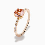 The Blush 14K Rose Gold Morganite and Diamond Ring features a large oval peach morganite center and sparkling diamonds along the band, shown on a white background.