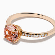 The Blush 14K Rose Gold Morganite and Diamond Ring features a large oval peach morganite center and sparkling diamonds along the band, shown on a white background.