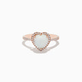The Aurora 14K Rose Gold Diamond and Opal Heart Ring features a heart-shaped opal center, sparkling diamonds encircling it, and additional diamonds set along the elegant rose gold band.