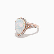 The Aurora 14K Rose Gold Pear Shaped Opal and Diamond Ring features a pear-shaped opal, a diamond halo, and diamond accents along the band, shown on a plain white background.
