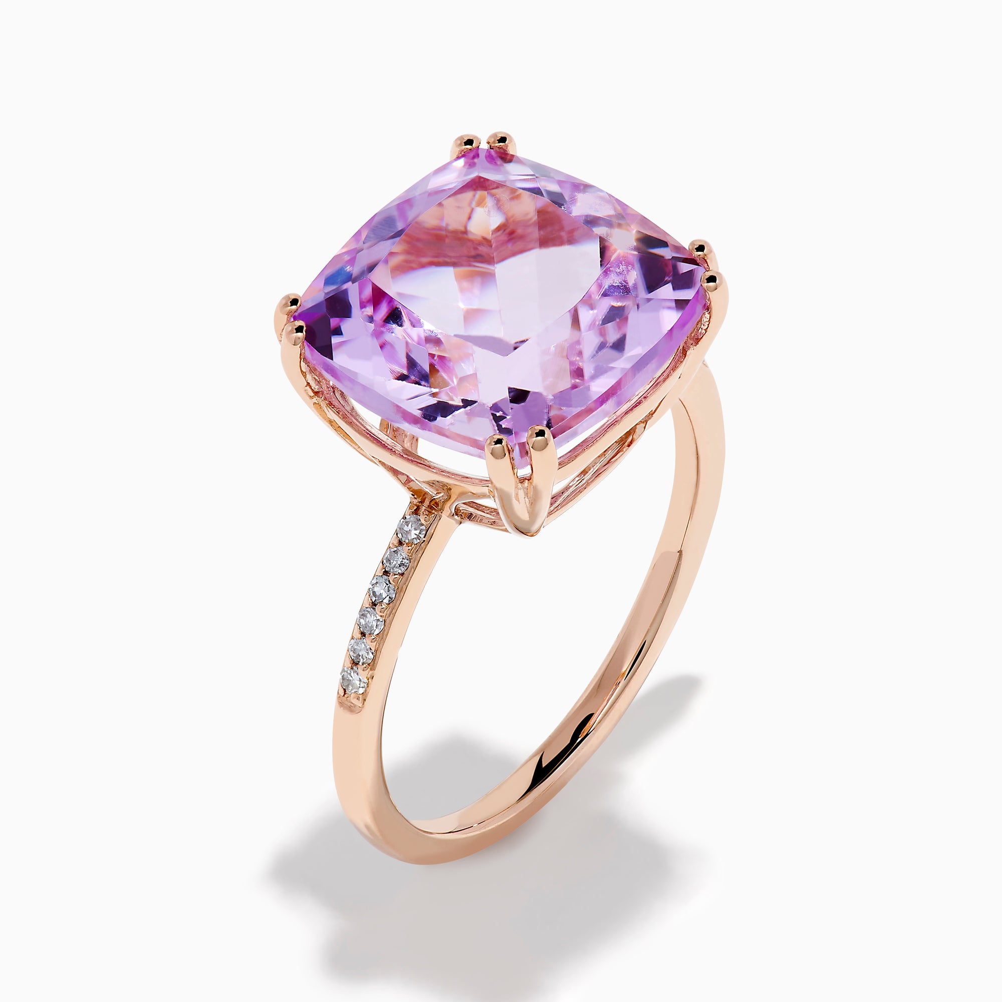 The 14K Rose Gold Kunzite and Diamond Ring features a striking cushion-cut kunzite gemstone at the center, accented with sparkling diamonds along the band.