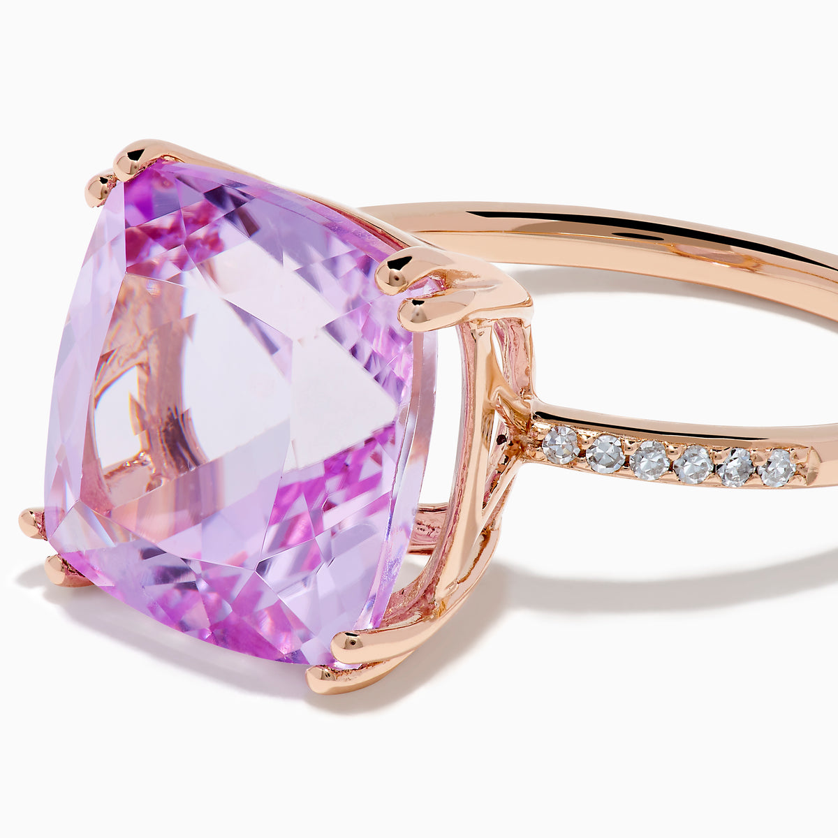 The 14K Rose Gold Kunzite and Diamond Ring features a striking cushion-cut kunzite gemstone at the center, accented with sparkling diamonds along the band.