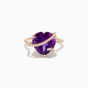 The 14K Rose Gold Amethyst and Diamond Heart Ring features a large heart-shaped amethyst set in rose gold, accented by a diamond-encrusted band, shown on a white background.
