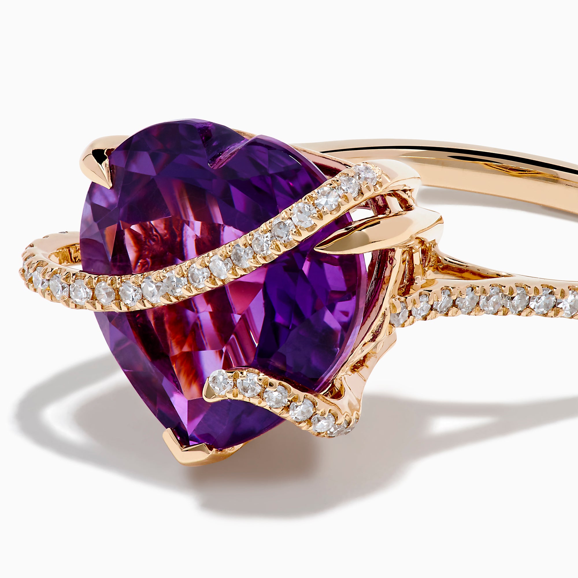 The 14K Rose Gold Amethyst and Diamond Heart Ring features a large heart-shaped amethyst set in rose gold, accented by a diamond-encrusted band, shown on a white background.