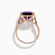 The 14K Rose Gold Amethyst and Diamond Ring showcases an oval amethyst with a diamond halo set on a rose gold band, displayed against a plain white background.