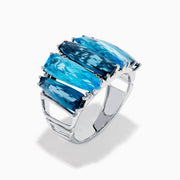 A striking 14K White Gold Blue Topaz and Diamond Statement Ring featuring seven large rectangular blue topaz stones arranged vertically, accented with diamonds—an elegant and eye-catching design.