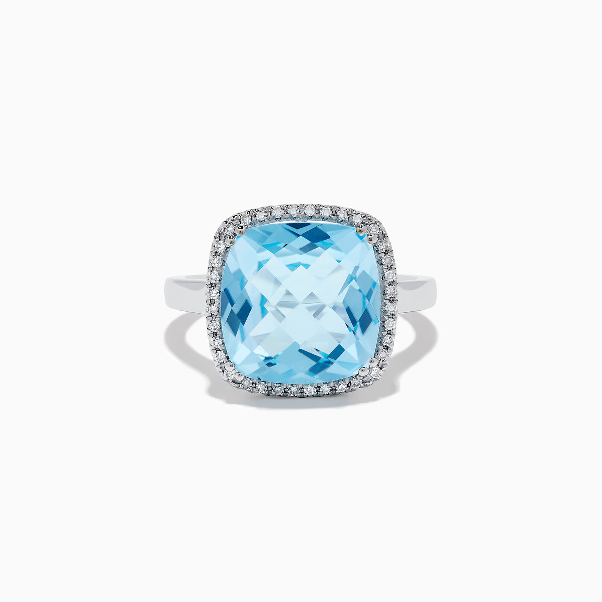 The Ocean Bleu 14K White Gold Blue Topaz and Diamond Ring showcases a large cushion-cut blue topaz center, bordered by sparkling diamonds, all set against a plain white background.