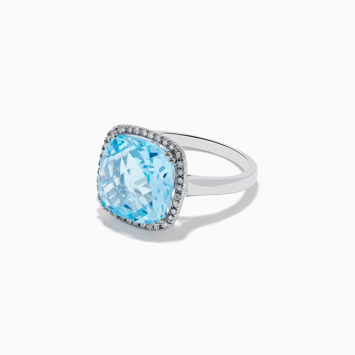 The Ocean Bleu 14K White Gold Blue Topaz and Diamond Ring showcases a large cushion-cut blue topaz center, bordered by sparkling diamonds, all set against a plain white background.