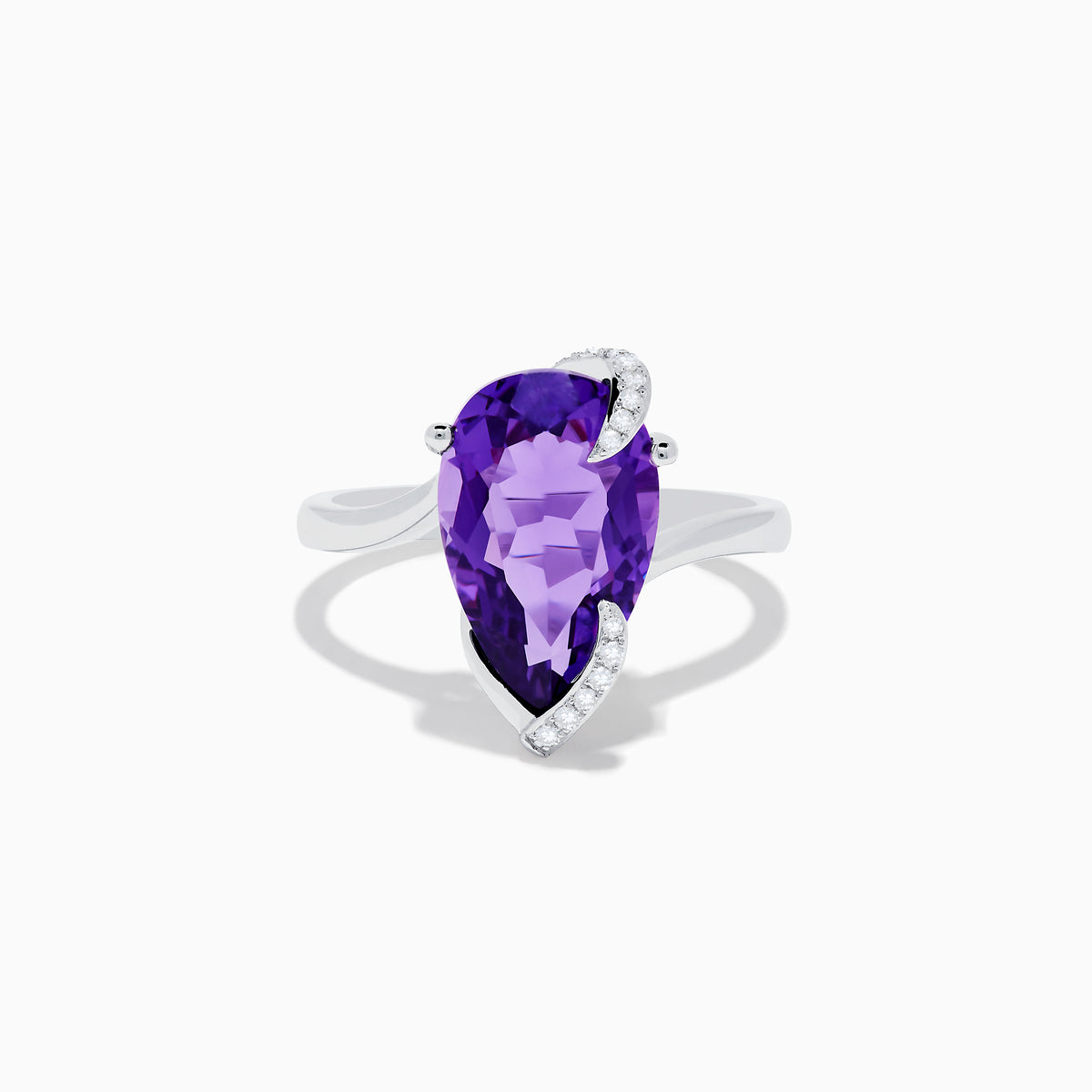 The 14K White Gold Amethyst and Diamond Ring features a large pear-shaped amethyst accented by small diamonds in a curved design, shown on a plain white background.