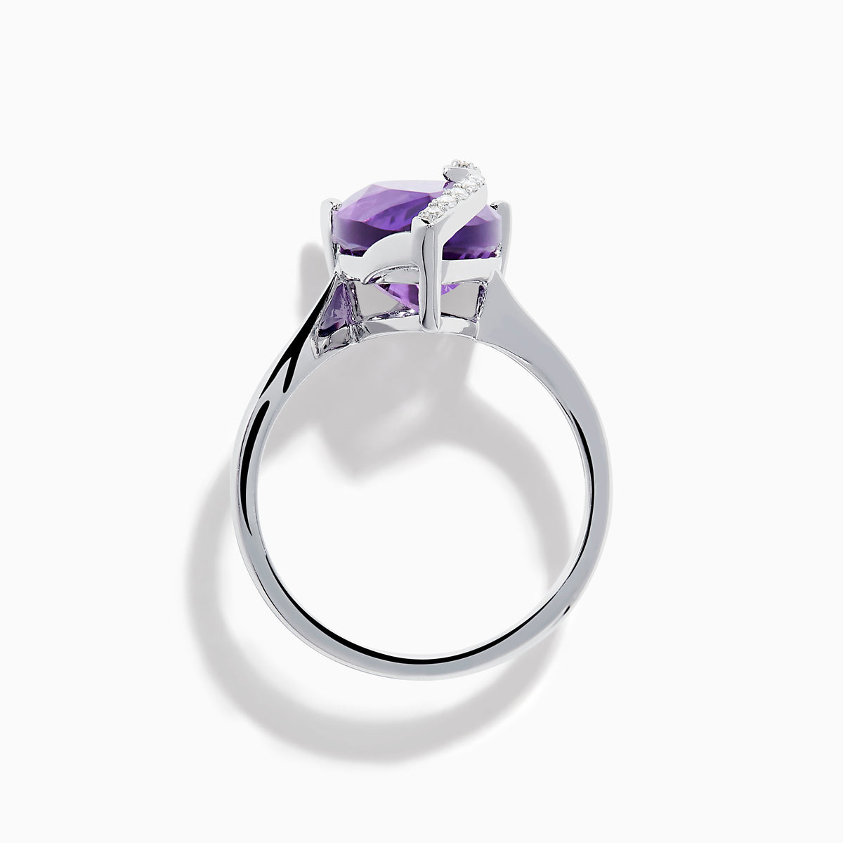 The 14K White Gold Amethyst and Diamond Ring features a large pear-shaped amethyst accented by small diamonds in a curved design, shown on a plain white background.