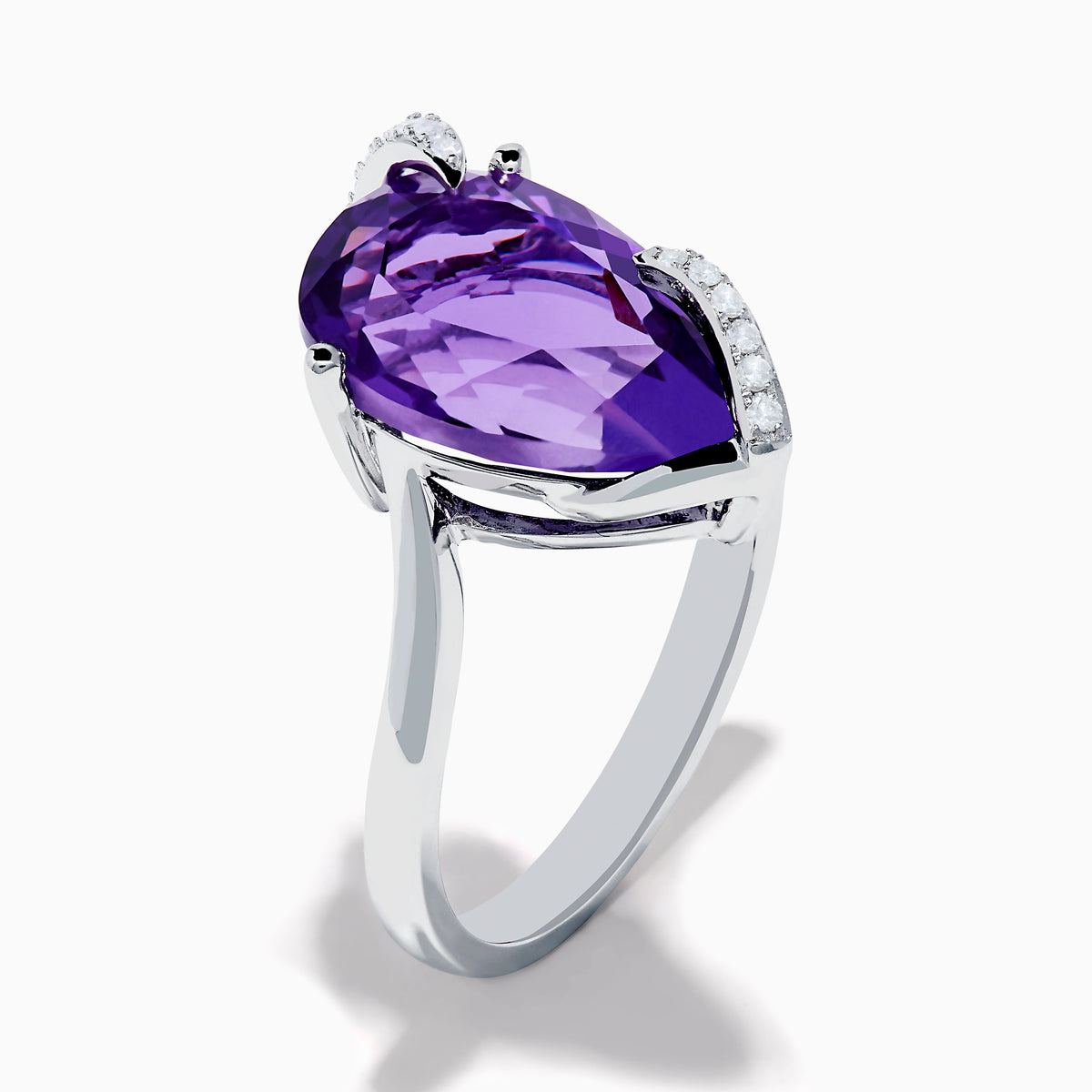 The 14K White Gold Amethyst and Diamond Ring features a large pear-shaped amethyst accented by small diamonds in a curved design, shown on a plain white background.