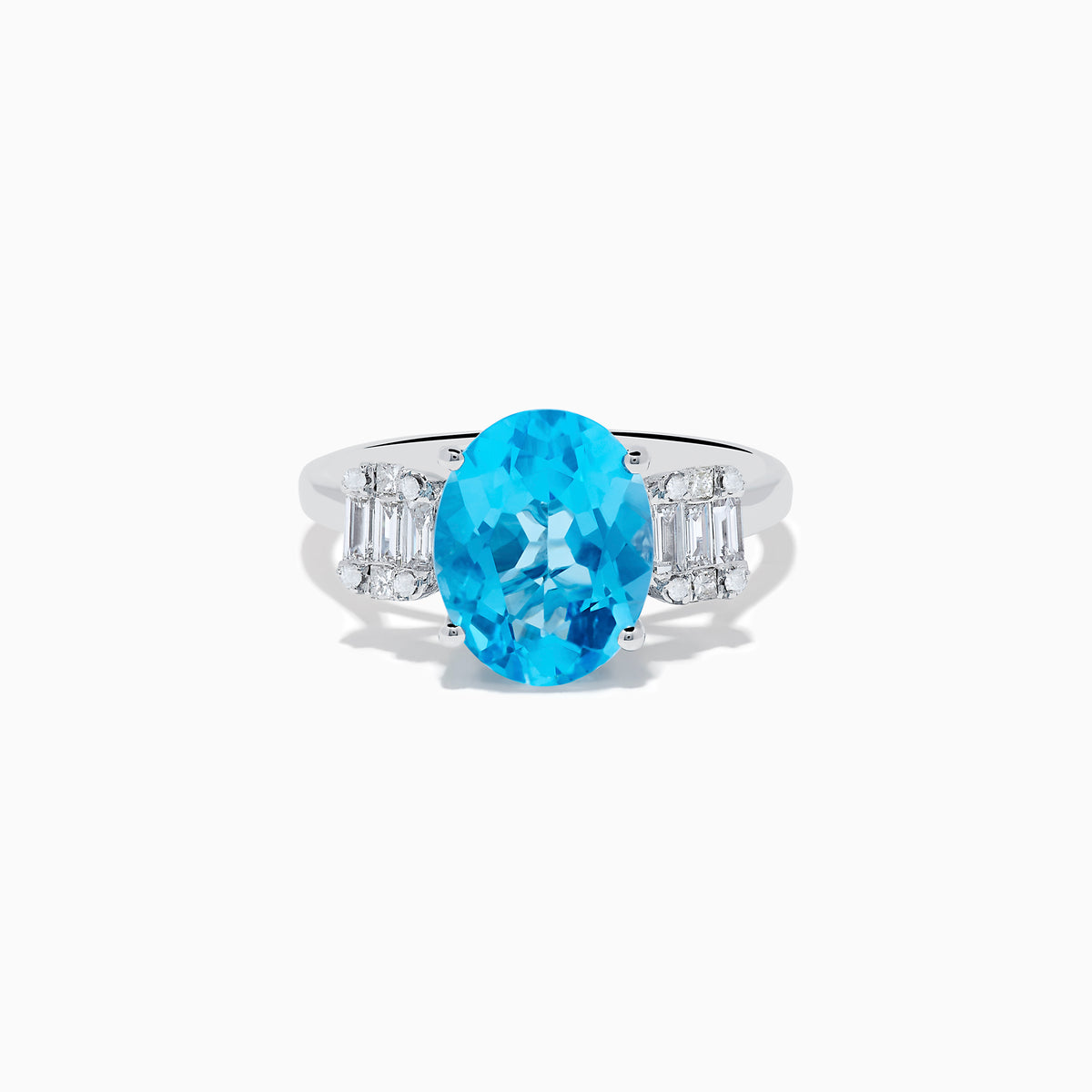 The Ocean Bleu 14K White Gold Blue Topaz and Diamond ring showcases a large oval blue topaz center stone, accented by two rectangular diamonds on each side, set against a white background.